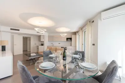 a dining room with a glass table and chairs at 3-Br Apartment with Pool Parking & Beaches 100m away in Cannes
