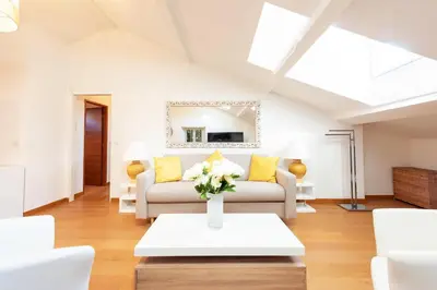a living room with a couch and a table at Elegant 1-Br apartment 3 minutes from la Croisette in Cannes