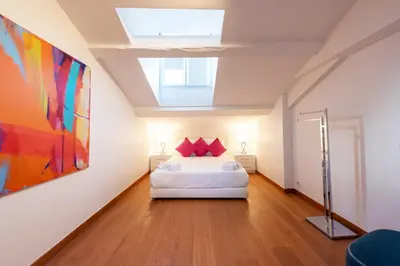 a bedroom with a bed and a painting on the wall at Elegant 1-Br apartment 3 minutes from la Croisette in Cannes