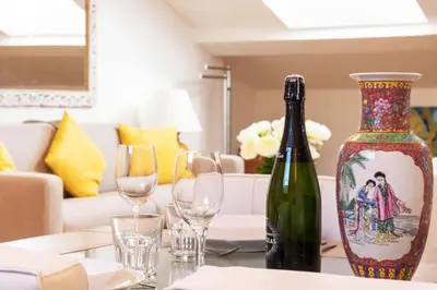 a bottle of wine sitting on a table with glasses at Elegant 1-Br apartment 3 minutes from la Croisette in Cannes
