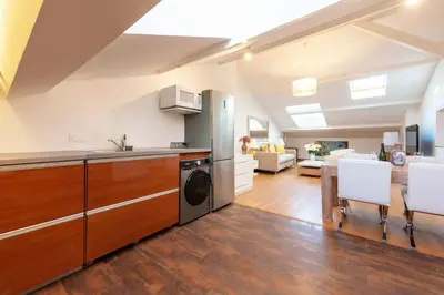 a kitchen and living room with a washer and dryer at Elegant 1-Br apartment 3 minutes from la Croisette in Cannes