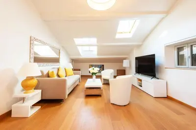 a living room with a couch and a tv at Elegant 1-Br apartment 3 minutes from la Croisette in Cannes