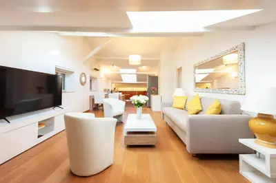 a living room with a couch and a tv at Elegant 1-Br apartment 3 minutes from la Croisette in Cannes