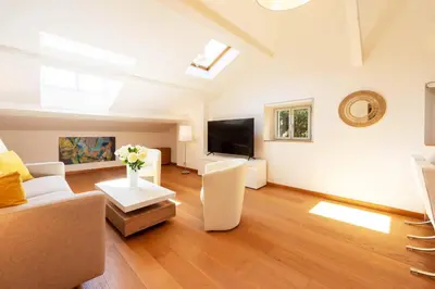 a living room with a couch and a tv at Elegant 1-Br apartment 3 minutes from la Croisette in Cannes
