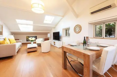a living room with a table and a couch at Elegant 1-Br apartment 3 minutes from la Croisette in Cannes