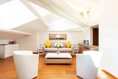 a living room with white furniture and yellow pillows at Luxurious StudioLoft 3 MINUTES FROM LA CROISETTE in Cannes