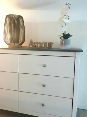 a white dresser with a lamp on top of it at le cosy de carole in Cannes