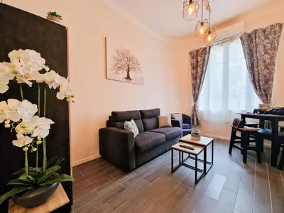 a living room with a couch and a table at le cosy de carole in Cannes
