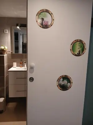 a bathroom with two plates on a white refrigerator at le cosy de carole in Cannes