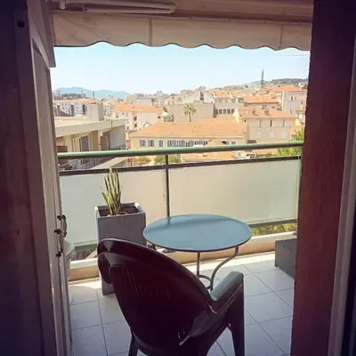 a view of a balcony with a table and chairs at Apt calme 2 chambres vue dégagée in Cannes