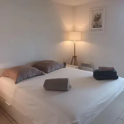 a large white bed with two pillows on it at Apt calme 2 chambres vue dégagée in Cannes