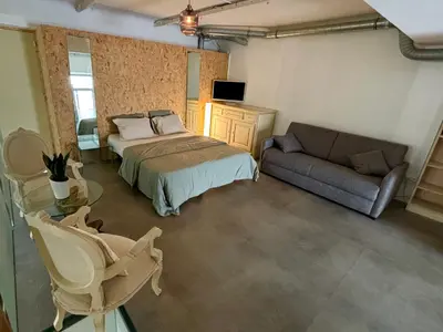 a bedroom with a bed and a couch at Radiance Private Bedroom & Breakfast in Cannes