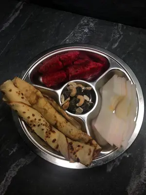 a metal plate of food with cheese and other foods at Radiance Private Bedroom & Breakfast in Cannes