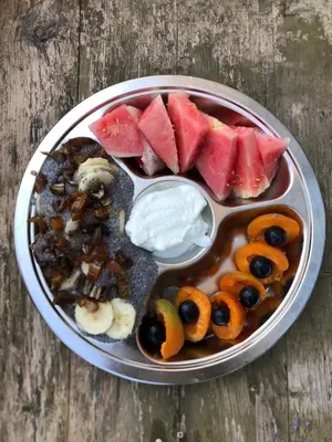 a tray of food with fruit and dip on a table at Radiance Private Bedroom & Breakfast in Cannes