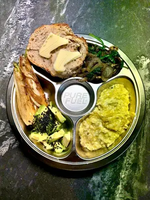 a plate of food with eggs and bread and vegetables at Radiance Private Bedroom & Breakfast in Cannes