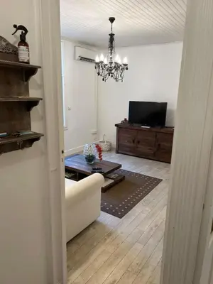 a living room with a couch and a chandelier at C090 Appartement confortable proche du Suquet et du Palais des festivals in Cannes