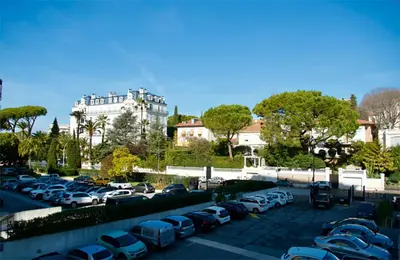 a parking lot with many cars parked in it at Triplex Gallia Luxe Cannes in Cannes