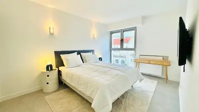 a white bedroom with a bed and a window at Verdalia luxury 3 bedroom by Welcome to Cannes in Cannes