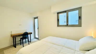 a bedroom with a bed and a desk and a window at Verdalia luxury 3 bedroom by Welcome to Cannes in Cannes