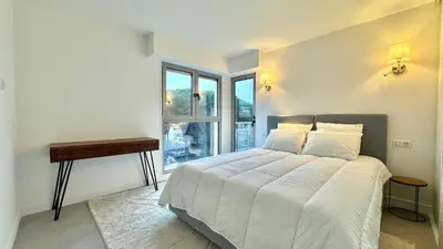 a bedroom with a bed and a desk and a window at Verdalia luxury 3 bedroom by Welcome to Cannes in Cannes