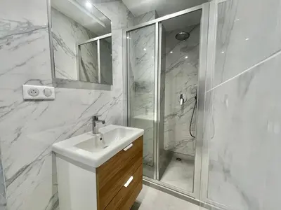 a white bathroom with a sink and a shower at Verdalia luxury 3 bedroom by Welcome to Cannes in Cannes