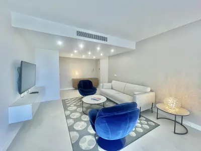 a living room with a couch and two blue chairs at Verdalia luxury 3 bedroom by Welcome to Cannes in Cannes