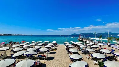 a bunch of umbrellas on a beach with the ocean at Studio Suquet Near Palais Et Plages in Cannes