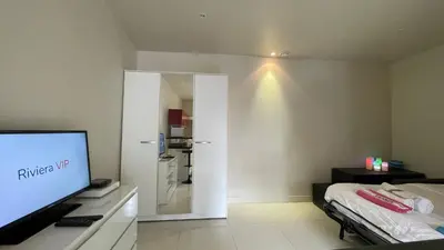a living room with a television and a kitchen at Studio Suquet Near Palais Et Plages in Cannes