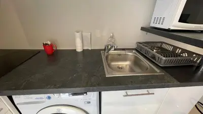 a kitchen counter with a sink and a washing machine at Studio Suquet Near Palais Et Plages in Cannes