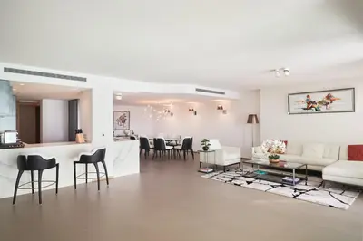 a white living room with a couch and a table at First Croisette in Cannes