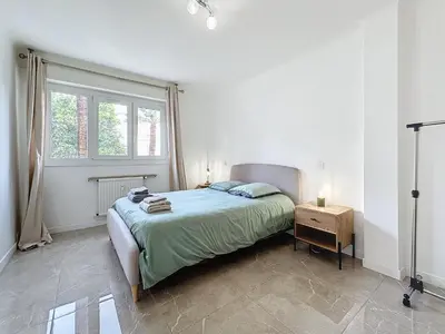 a white bedroom with a bed and a window at INTUITION - 3 pieces - 10min Croisette in Cannes