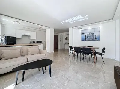a living room with a couch and a table and chairs at INTUITION - 3 pieces - 10min Croisette in Cannes
