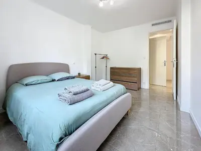 a bedroom with a large bed with towels on it at INTUITION - 3 pieces - 10min Croisette in Cannes