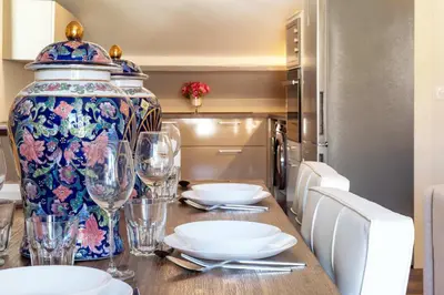 a dining room table with a large vase on it at Exquisite 2-Br apartment 3 minutes from la Croisette in Cannes