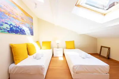 a room with two beds and a painting on the wall at Exquisite 2-Br apartment 3 minutes from la Croisette in Cannes
