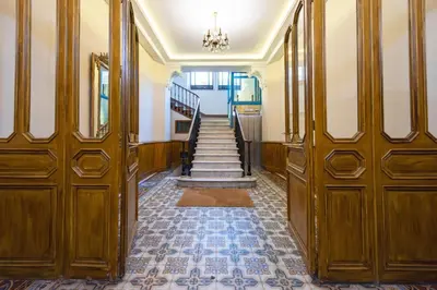 a hallway with wooden doors and stairs in a building at Exquisite 2-Br apartment 3 minutes from la Croisette in Cannes