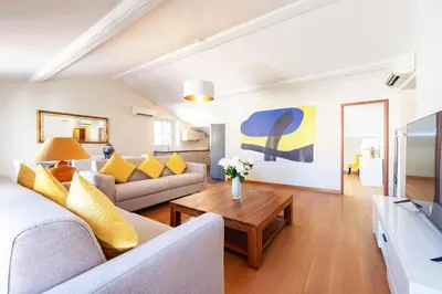 a living room with a couch and a table at Exquisite 2-Br apartment 3 minutes from la Croisette in Cannes