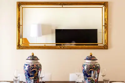 two vases sitting on a table in front of a mirror at Exquisite 2-Br apartment 3 minutes from la Croisette in Cannes