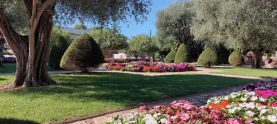a park with a bunch of flowers and trees at Les Orangers - Cannes - Sea View- Swimming Pool - Free Parking - Beach in Cannes