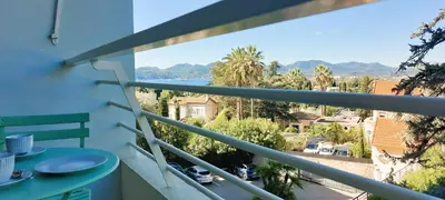 a balcony with a table and a view of the ocean at Les Orangers - Cannes - Sea View- Swimming Pool - Free Parking - Beach in Cannes