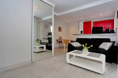 a living room with a couch and a table at T2 centre-ville Banane à Cannes avec grande terrasse in Cannes