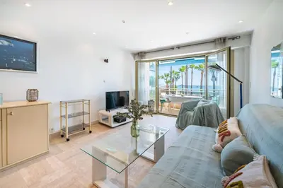 a living room with a couch and a glass table at Croisette vue mer 2 pièces in Cannes