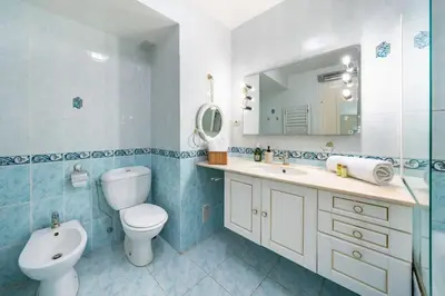a bathroom with a toilet and a sink and a mirror at Croisette vue mer 2 pièces in Cannes