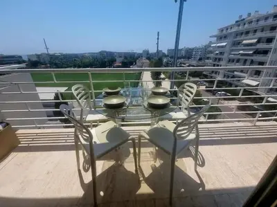 a glass table and chairs on a balcony at New top floor avec vue mer, Croisette à Palm Beach in Cannes