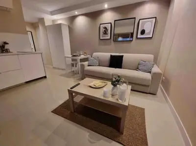 a living room with a couch and a table at New top floor avec vue mer, Croisette à Palm Beach in Cannes