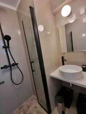 a bathroom with a glass shower and a sink at New top floor avec vue mer, Croisette à Palm Beach in Cannes