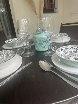 a table with plates and wine glasses on it at Le cannois in Cannes