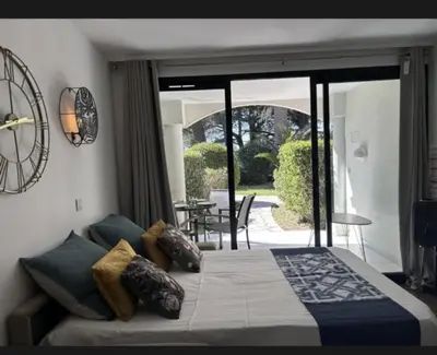 a bedroom with a bed and a sliding glass door at Le cannois in Cannes