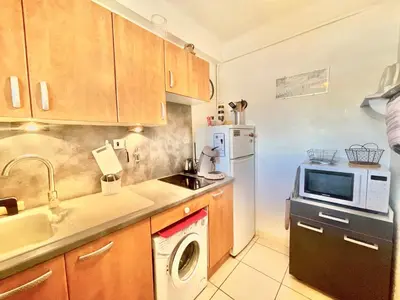 a kitchen with a sink and a microwave at Le Petit Magellan by Welcome to Cannes in Cannes