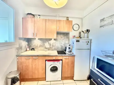 a kitchen with a washing machine and a washer at Le Petit Magellan by Welcome to Cannes in Cannes